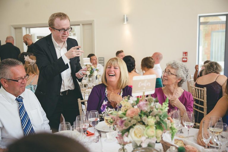 Table magician entertaining guests at a wedding