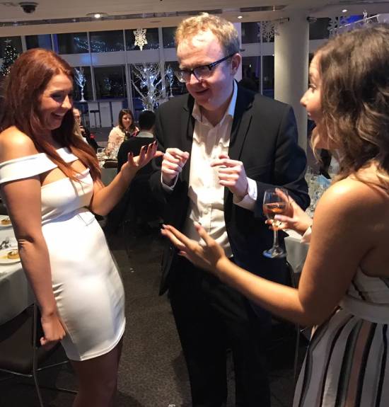 Close-up magician with amazed women